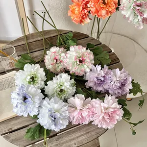Faux peony and dahlia bouquet in pastel colors on a wooden table for home decor