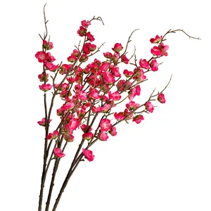 Artificial cherry blossom branch in vivid magenta with realistic texture for home decor