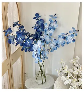 Close-up of 3D printed blue gradient butterfly orchid in a minimalist glass vase