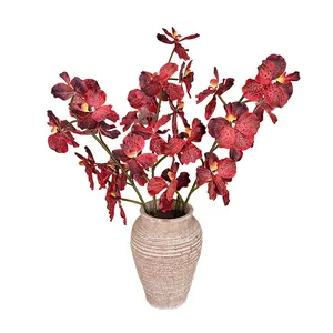 3D printed orchid with red-brown spotted petals in a stone-textured ceramic vase