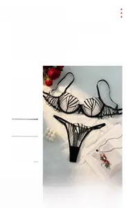Detail view of sheer black lace lingerie set with semi-cup bra on white faux fur background