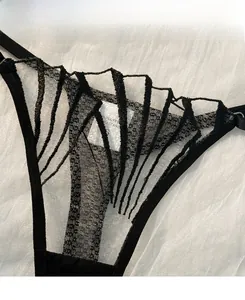 Close-up of black lace mesh underwear with intricate embroidery and polyester fabric detail