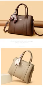 Detailed view of leather handbags in brown and beige with stylish silk scarf handles