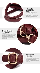 Detail of burgundy lychee grain leather handbag featuring thick handles and gold metal hooks