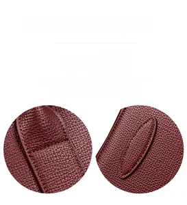 Close-up of wine red lychee leather handbag showing reinforced stitching and base detail