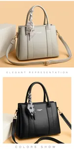 Detail of leather tote bag with elegant silk scarf and golden metallic hardware parts