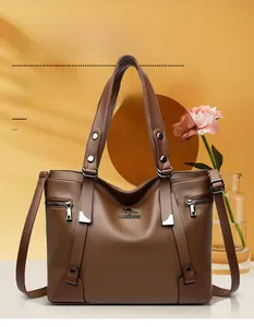 Detail of dark brown pebble leather bag with kangaroo logo and metallic silver hardware