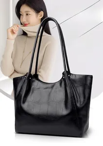Close-up of black stone textured tote bag with elegant thin shoulder straps