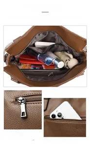 Detail of premium brown leather tote with large capacity compartments and metal zipper