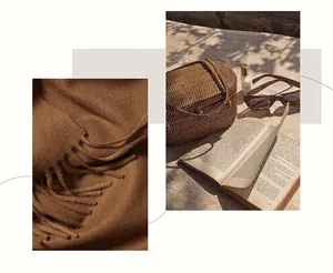Close-up of caramel vintage leather bag with stone texture and tassels in sunlight