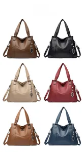 Detailed view of six colors of leather handbags with leaf pendant and shoulder strap