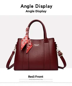 Close-up of wine red lychee leather tote bag with silk scarf and gold metal hardware