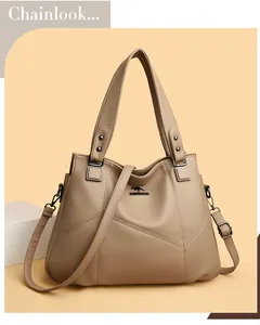 Detail of khaki leather handbag featuring lychee texture and metallic kangaroo logo