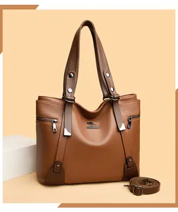 Detail of brown litchi pattern leather tote bag with metal kangaroo logo and strap