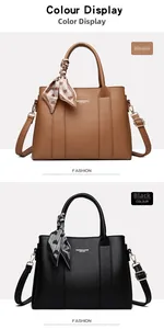 Detail of leather handbags in black and khaki with decorative heart scarves and shoulder straps