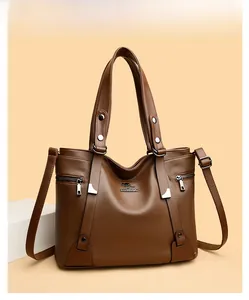 Detail of brown litchi pattern leather tote bag with silver metal kangaroo logo