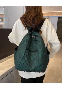 Dark green punk backpack with bamboo leaf pattern and black metal rivets detail.