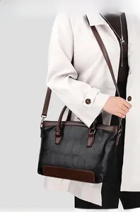Close-up of stone pattern leather texture on a two-tone black and brown handbag