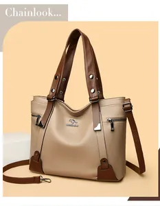 Detailed view of the beige and brown contrast leather texture with silver hardware accents