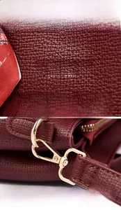 Detail of wine red lychee leather texture and gold hardware with decorative silk scarf