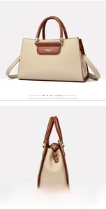 Détail d'un sac cabas élégant en cuir abricot avec anses marron et logo de mode