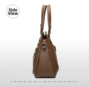Side view of brown lychee grain leather tote with pearl chain and heart charm detail