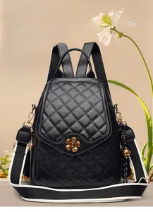 Close-up of a black quilted leather backpack with a golden plum blossom twist lock detail