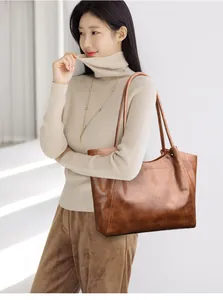 Brown crocodile embossed leather tote bag shown on model for stylish daily commuting