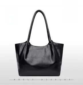Close-up of black stone pattern leather tote bag with fine stitching and slim handles