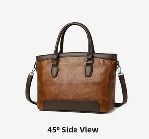 45-degree side view of a brown stone pattern leather handbag with dark handles