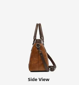 Side view of retro brown leather handbag showing stone texture and metallic hardware
