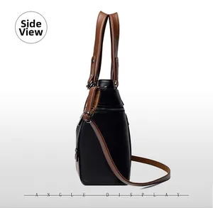 Side view of black pebble leather tote bag with brown handles and silver metal hardware