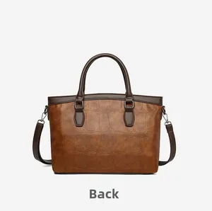 Detailed back view of a vintage brown handbag with crocodile embossing and sturdy handles