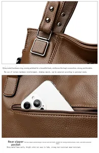 Detail of brown litchi leather bag with silver buckle and anti-theft back zipper pocket