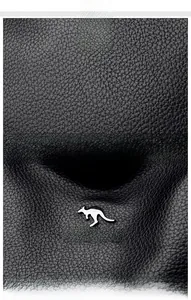 Close-up of black lychee grain leather texture and silver kangaroo logo hardware on bag