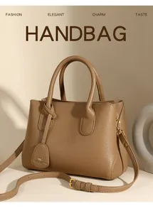 Macro detail of brown pebble leather handbag texture with golden metal hardware