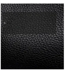 Close-up of premium black lychee-textured leather with soft, durable, and natural grain