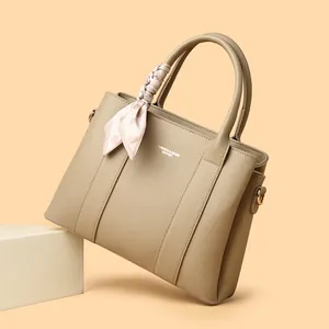Elegant khaki pebbled leather tote bag for women with decorative floral silk scarf handle