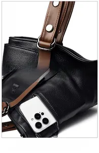 Detail showing high-quality leather texture, side zipper pocket, and silver hardware