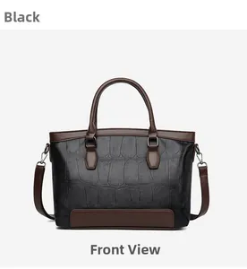 Front view of black crocodile embossed handbag with brown handles and silver hardware