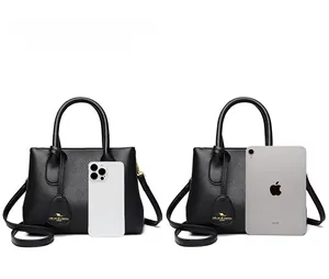 Black pebbled leather handbag size comparison with iPad and smartphone models