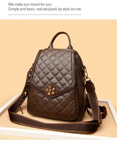 Detail of dark brown quilted backpack featuring a gold flower-shaped metal twist lock closure