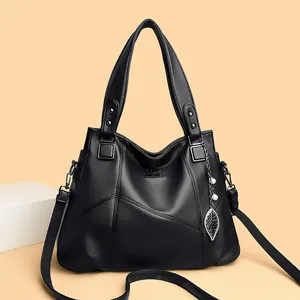 Black lychee leather tote bag with kangaroo logo, leaf pendant and woven strap