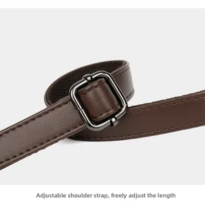 Close-up of adjustable leather shoulder strap with gunmetal buckle for tote bag