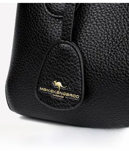 Close-up of black lychee grain leather texture with gold kangaroo logo on handbag