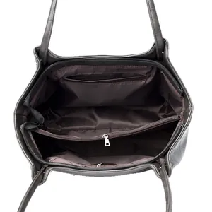 Top view of faux leather tote bag interior with multiple compartments and silver zippers
