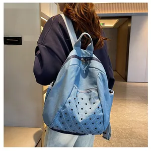 Detail view of denim backpack featuring punk rock rivets and diamond quilted stitching