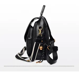 Side view of black quilted leather backpack featuring gold hardware and contrast strap