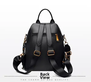 Back view of black leather backpack with adjustable straps and gold metal zipper pocket