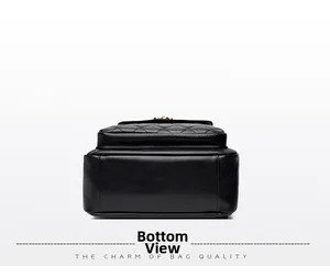 Detail view of the black pebbled leather bottom and quilted texture of the bag